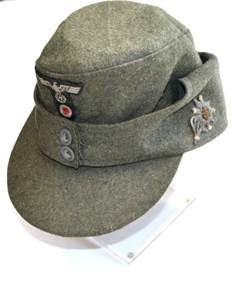 Lot 195 - A German Third Reich Mountain Trooper's Overseas Cap, in field grey wool with fold down back...