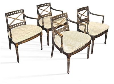 Lot 518 - A Set of Four Regency Ebonised and Parcel Gilt Armchairs, early 19th century, the X shaped back...