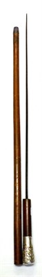 Lot 286 - A Malacca Swordstick, with 61cm fullered steel blade, the handle with silver collar and pommel...