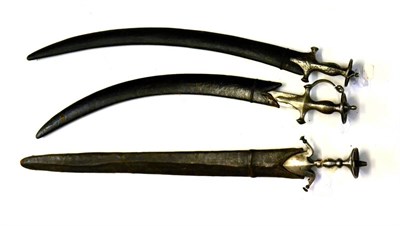 Lot 301 - An Indian Tulwar, the broad, double-edged blade, length 77.5 cm, with Pulouar-style hilt,...