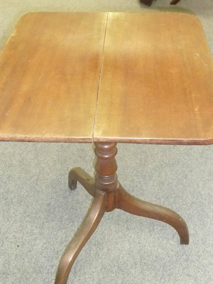 Lot 524 - A George IV Flip-Top Tripod Table, the rectangular top raised on a turned baluster support with...