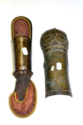 Lot 310 - An Indian Pata (Armguard), with relief devil mask decoration (attached sword blade lacking),...