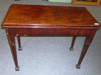 Lot 526 - A George III Mahogany Foldover Table, late 18th century, the hinged top above a plain frieze...