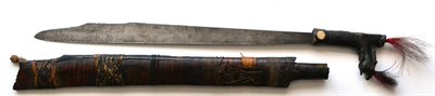 Lot 335 - A Dyak Mandau (Headhunter's Sword), 52.5cm single edge steel blade, the wood saw handled hilt...