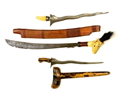 Lot 341 - A Dyak Mandau (Headhunter's Sword), the 53cm single edge curved steel blade, the bone hilt...