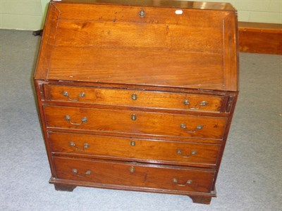 Lot 530 - A Late George III Oak Bureau, early 19th century, the fall enclosing an adapted interior of...