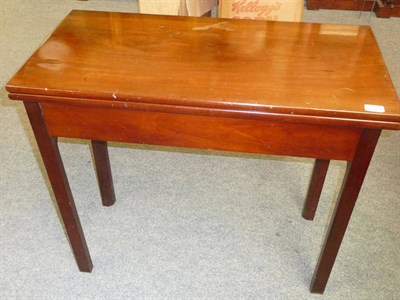 Lot 545 - A George III Mahogany Foldover Tea Table, circa 1800, the rectangular hinged top above a plain...