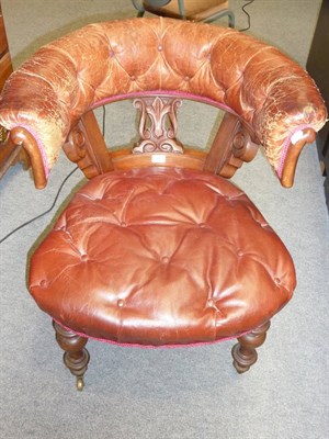 Lot 557 - A Victorian Mahogany Framed Open Armchair, late 19th century, upholstered in faded button brown...