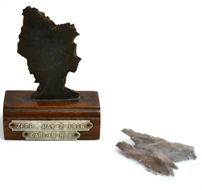 Lot 153 - German Zeppelin Bombardment: First World War Shell Fragment, mounted on a moulded oak base, bearing