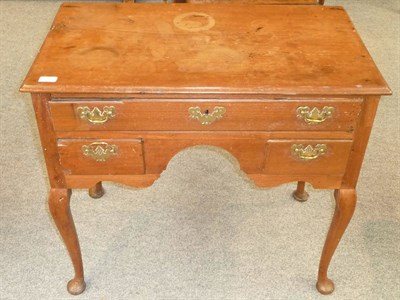 Lot 558 - A George III Walnut Kneehole Dressing Table, late 18th century, the single frieze drawer above...