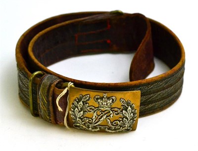 Lot 217 - A Late Victorian Gold Lace and Red Leather Waist Belt, the brass buckle applied with silver Queen's