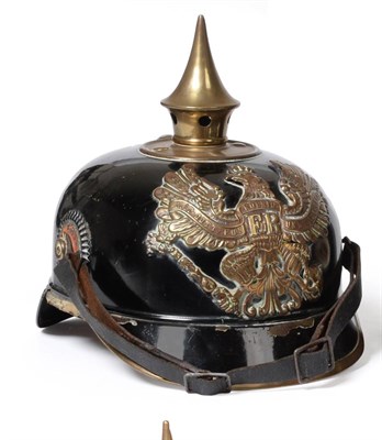 Lot 234 - A Prussian Ersatz Tin Pickelhaube, black painted and with stamped brass helmet plate, the brass...