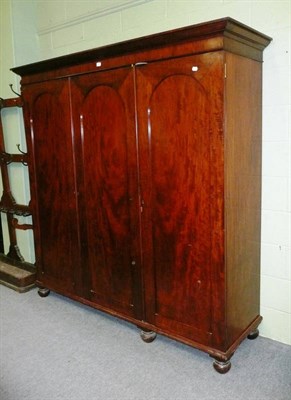 Lot 576 - A Victorian Mahogany Triple Door Wardrobe, late 19th century, the moulded cornice with plain...