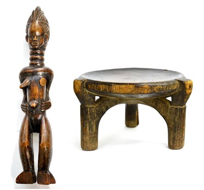 Lot 396 - An African Carved Wood Stool, the dished circular seat on three circular section supports conjoined