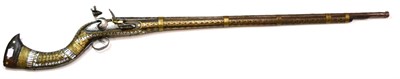 Lot 487 - A 19th Century Afghan Flintlock Jezail, the 103cm tapering steel barrel chased with a band of broad