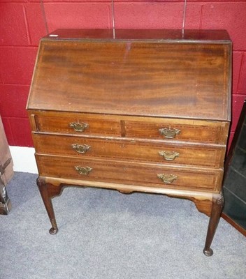 Lot 592 - An Edwardian Mahogany and Satinwood Banded Bureau, the fall opening to reveal a fitted interior...