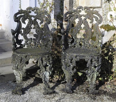 Lot 598 - A Pair of Victorian Cast Iron Open Scrollwork Garden Chairs, circa 1880-1900, currently painted...