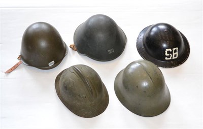 Lot 218 - A Second World War Brodie Helmet, painted black and with S.B. in white, the rubber liner straps...