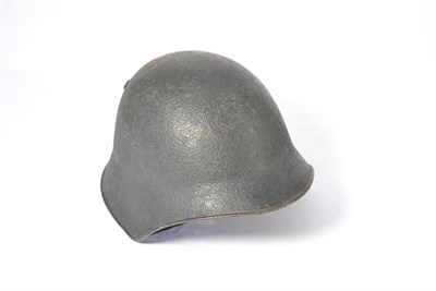 Lot 221 - A Second World War Swiss M18 Army Helmet, with textured black paint, the inner skull stencilled...