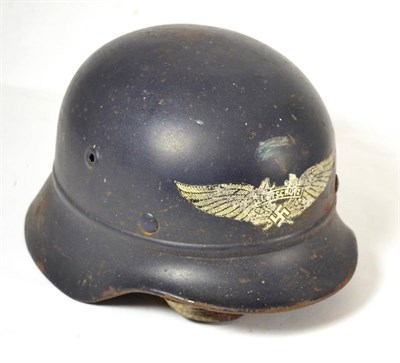 Lot 258 - A German Third Reich Luftschutz M40 Helmet, with dark  blue paint and silver decal, the back...