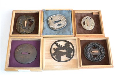 Lot 283 - A Japanese Iron Tsuba, possibly 18th century, incised with prunus blossom and leafy fronds...