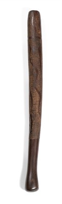 Lot 374 - An Australian Aborigine Dark Hardwood Pole Club, carved with sinuous snakes on a finely chip carved