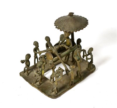 Lot 391 - An Asante Bronze Figure Group, modelled as a chief holding a gun, seated in a palanquin beneath...