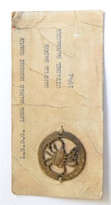 Lot 54 - A Rare Bronze Long Range Desert Group Sample Cap Badge, stitched to a card display inscribed...