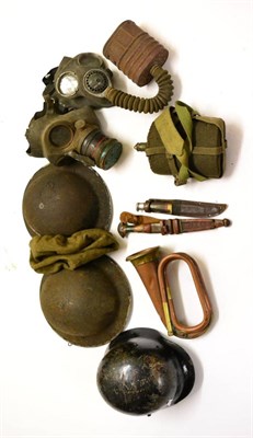 Lot 75 - Second World War Militaria, comprising two British Brodie helmets, a beret, two gas masks, a...