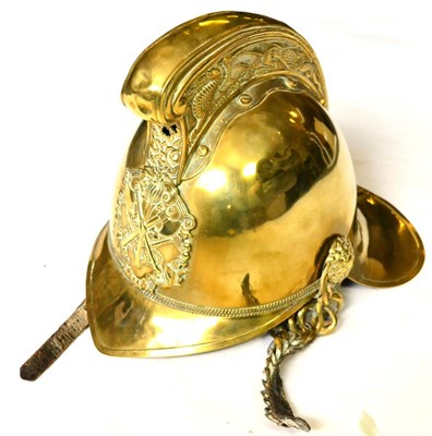 Lot 202 - A Victorian Fireman's Brass Helmet, the raised comb embossed with a dragon, the helmet plate...