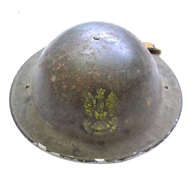 Lot 204 - A Second World War Brodie Helmet, the front painted with the Polish eagle in yellow, the inner brim