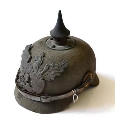 Lot 212 - A First World War Ersatz Pickelhaube, of field grey felt, the brass spike pierced with five...