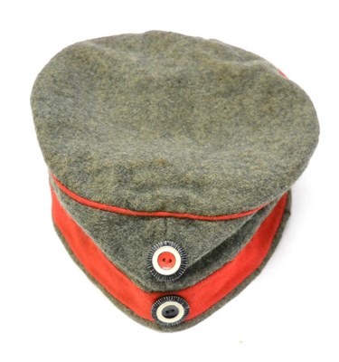 Lot 217 - An Imperial German M1907 Enlisted Man's Infantry Field Cap, with red band and piping, non...