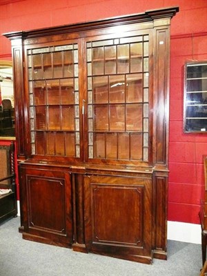 Lot 668 - A 19th Century Mahogany Glazed Breakfront Bookcase, the upper section with two glazed doors,...