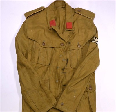 Lot 255 - A Second World War Italian Fascist Desert Jacket, from the North African campaign, with red...