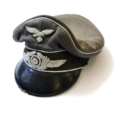 Lot 260 - A German Third Reich Luftwaffe Officer's Visor Cap, in blue/grey wool blend, with silver metal...