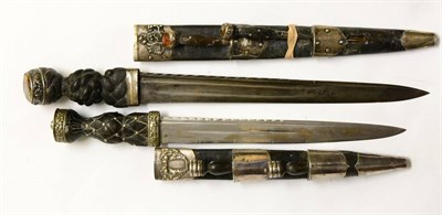 Lot 313 - A Late Victorian Scottish Dirk, with 34cm scallop back fullered steel blade, the ebony baluster...