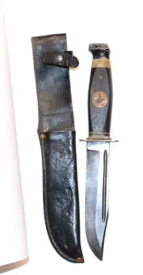 Lot 349 - A US Marine Corps Kabar Knife, the 15cm single edge fullered clip point steel blade stamped...