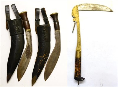 Lot 357 - Two Second World War Gurkha Kukris, each with wood grip and nickel pommel, leather scabbard and...