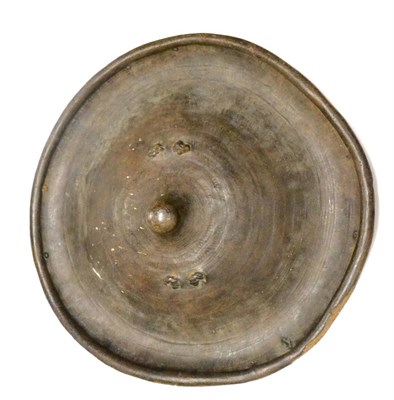 Lot 382 - A North African Hide Shield, of circular form, with dished and rolled borders, raised central...