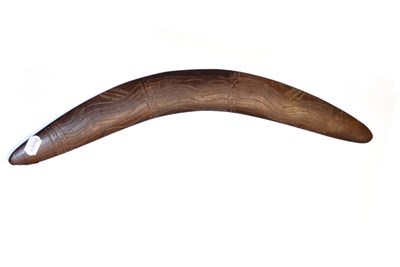 Lot 396 - An Australian Aborigine Boomerang, one side lightly carved with sinuous bands of diapering, 62cm