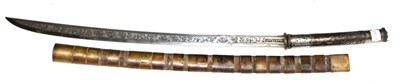 Lot 397 - An 18th Century Burmese Dha, the 60cm single edge curved steel blade richly inlaid in silver...