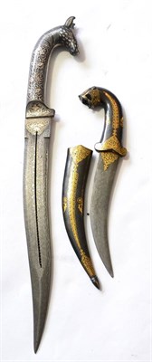 Lot 399 - An Indian Small Dagger, with curved pamor steel blade, the blued steel hilt with tiger's head...