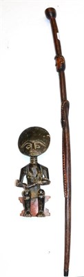 Lot 407 - An Asante 'Akuaba' Fertility Figure, of ebonised wood, seated holding a baby on a red painted...