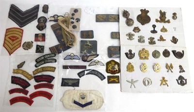 Lot 97 - A Collection of Militaria, including thirty cloth insignia, thirty eight cap and collar badges,...