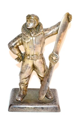 Lot 104 - A Second World War Silver Plated Table Lighter, modelled as an RAF pilot standing holding a...