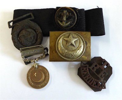 Lot 124 - Militaria, comprising a First World War Turkish belt buckle, in brass and white metal; an...