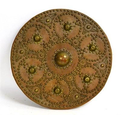 Lot 183 - A Scottish Targe, covered in tan leather with brass studded decoration enclosing a raised boss, the