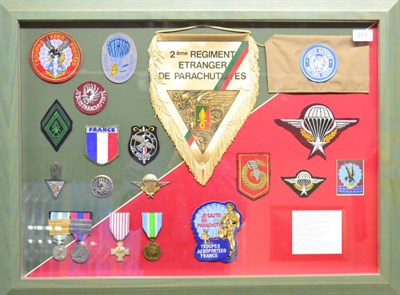 Lot 201 - French Foreign Legion, a framed display including medals, cloth and metal badges, pennant and...