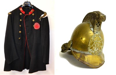 Lot 232 - An Early 20th Century Fireman's Brass Merryweather Helmet and Blue Wool Tunic, the helmet with...